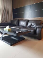 Modern living room with a leather sofa and glass coffee table