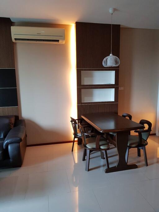 Modern living and dining area with a table, chairs, and air conditioning