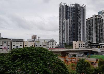 View of urban buildings from a distance on a cloudy day