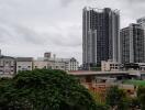 View of urban buildings from a distance on a cloudy day