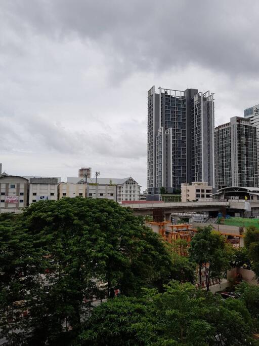 View of urban buildings from a distance on a cloudy day