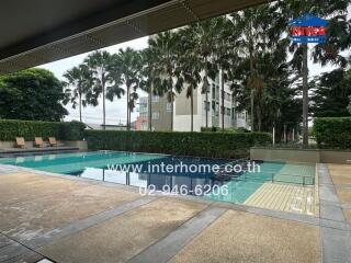 Swimming pool area with lounge chairs