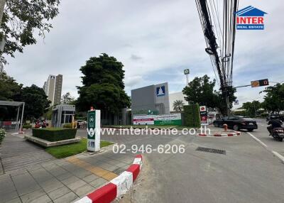 Street view with commercial buildings and greenery