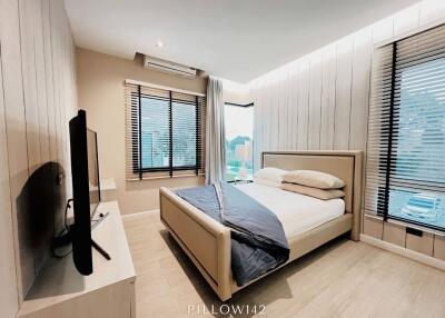 modern bedroom with large windows and double bed