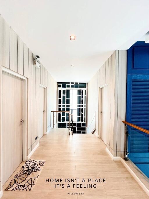 Modern hallway with light wood paneling and contemporary decor