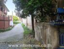 Pathway and exterior building view with greenery