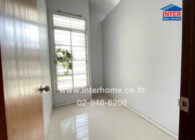 Empty bedroom with window and tiled floor