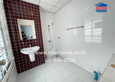 Clean bathroom with tiled walls and a sink