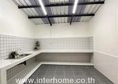 Modern kitchen with white tile backsplash and countertop