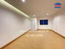 Spacious unfurnished room with white walls and wooden floor