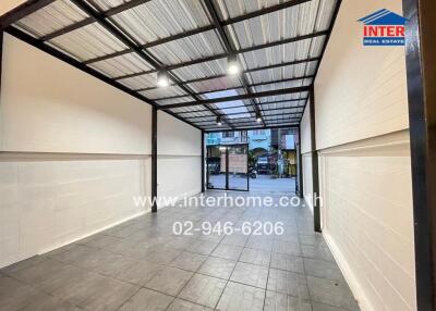 Covered parking space with a metal roof and tiled flooring