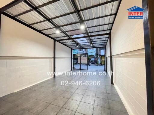 Covered parking space with a metal roof and tiled flooring