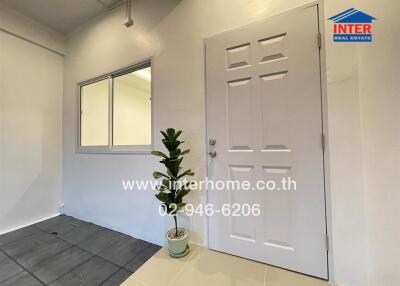 Entryway with a potted plant and window