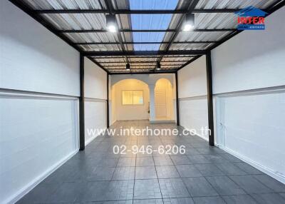 Modern entryway with transparent roof and white walls