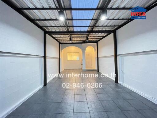 Modern entryway with transparent roof and white walls