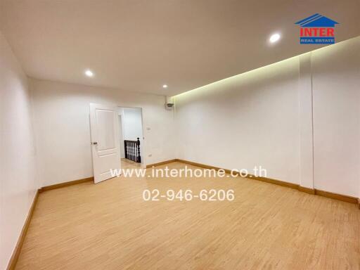 Spacious living room with wooden flooring and ceiling lights