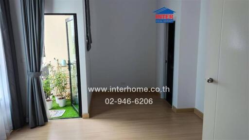 Room with hardwood floor and door to outdoor area