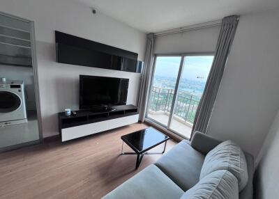 Contemporary living room with a TV and balcony access