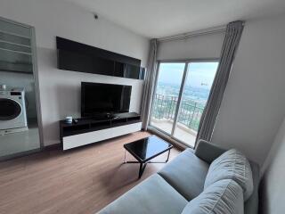 Contemporary living room with a TV and balcony access