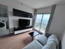 Contemporary living room with a TV and balcony access