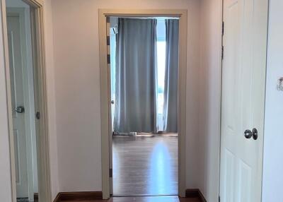 Hallway with wooden floor and doors