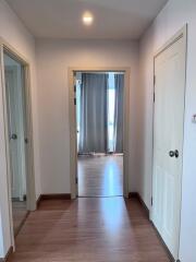 Hallway with wooden floor and doors