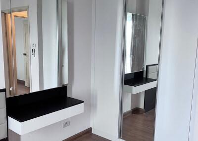 Modern bedroom with vanity and mirror closet