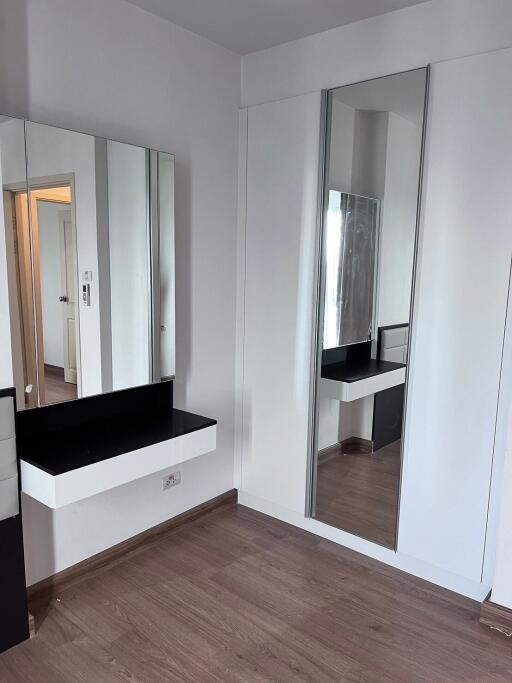 Modern bedroom with vanity and mirror closet