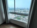 Bedroom with large window and city view