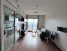 Modern living room with wood flooring and a balcony view.