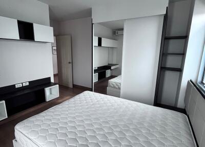 Modern bedroom with built-in storage and large mirror