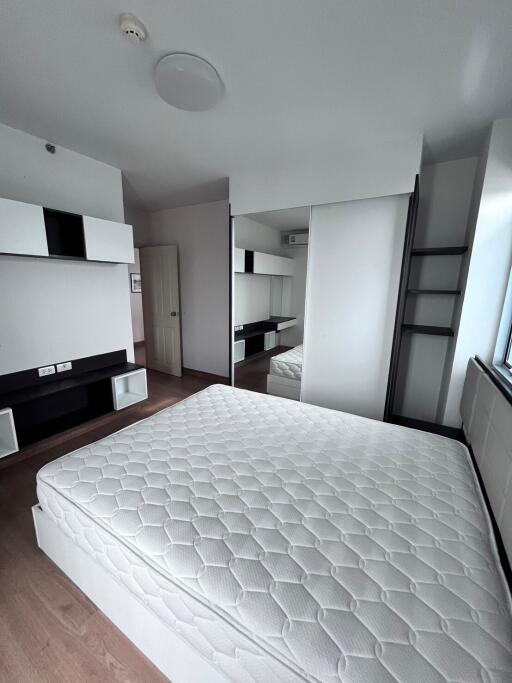 Modern bedroom with built-in storage and large mirror