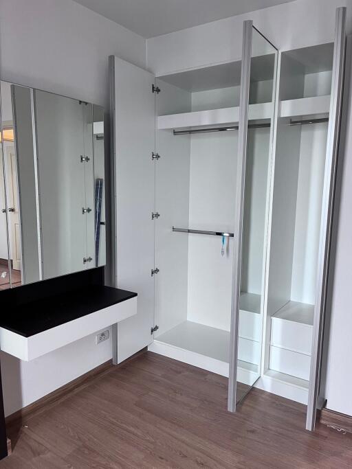 Modern bedroom closet with mirror and vanity