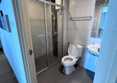 Modern bathroom with shower, toilet, and sink