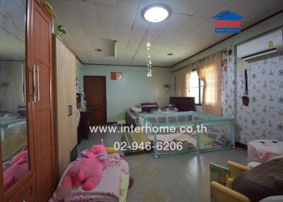 Bedroom with multiple beds and children