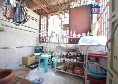 Utility/laundry room with various stored items and drying clothes