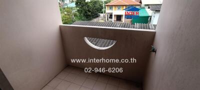 balcony with tiled floor, a small water tap, and a railing with a semicircular design opening