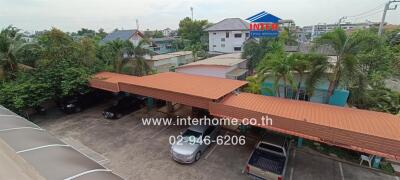 Covered parking area with surrounding greenery