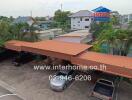 Covered parking area with surrounding greenery