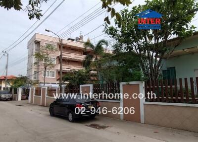 Street view of residential area with houses and parked cars