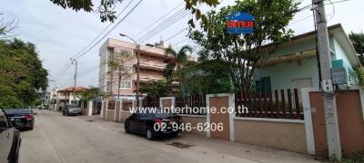 Street view of residential area with houses and parked cars