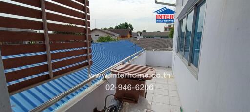 Outdoor balcony with a view of neighboring rooftops