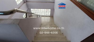 Staircase with glass block windows and stainless steel handrail