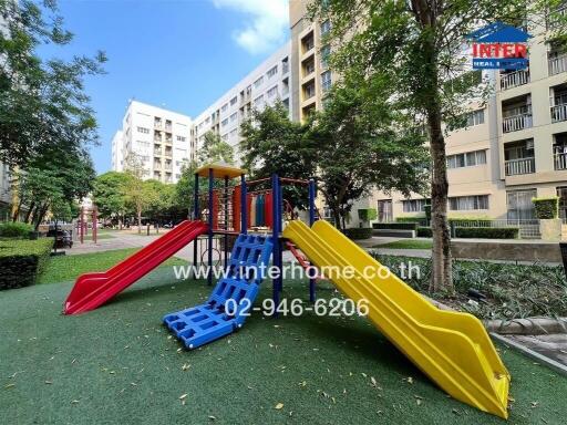 Playground area in apartment complex with slides and climbing equipment