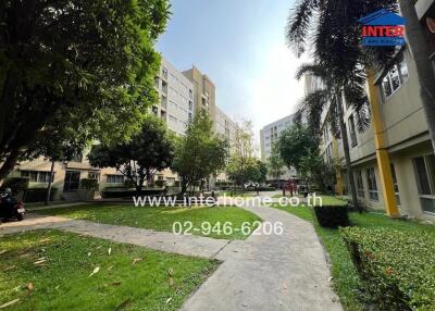 Outdoor view of residential complex with walkway and greenery