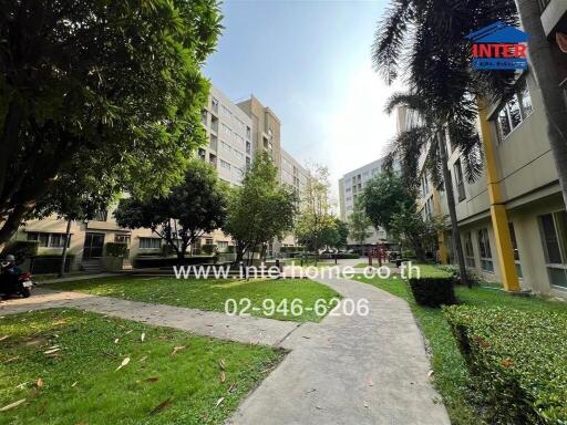 Outdoor view of residential complex with walkway and greenery