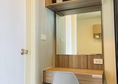 Bedroom with a small desk, chair, mirror, and shelves