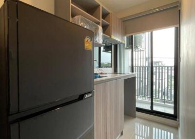 Modern kitchen with large fridge and balcony view