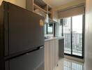 Modern kitchen with large fridge and balcony view