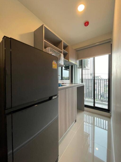 Modern kitchen with large fridge and balcony view